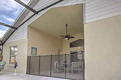 a patio with a dining table and a ceiling fan at Beautiful Kissimmee Home - 5 Mi to Disney World! in Kissimmee