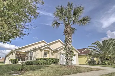 a palm tree in front of a house at Beautiful Kissimmee Home - 5 Mi to Disney World! in Kissimmee