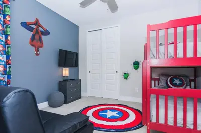 a room with a captain america bedroom with a red bunk bed at Amazing Home w a Private Pool in Orlando