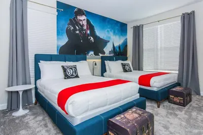 a bedroom with two beds and a painting on the wall at Gorgeous 5 Beds Home with Game Room and Pool in Kissimmee