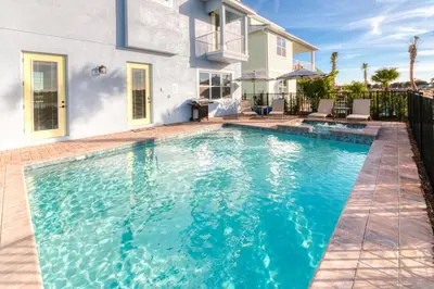 a swimming pool in front of a house at 3 Story Cottage With Private Pool Near Disney With Margaritaville Resort & Island H20 Access - 8105Su in Orlando