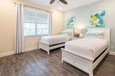 a bedroom with two beds and a window at 3 Story Cottage With Private Pool Near Disney With Margaritaville Resort & Island H20 Access - 8105Su in Orlando
