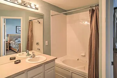 a bathroom with a sink and a bath tub at Our Mickey Mouse House Townhome with Pool! in Orlando