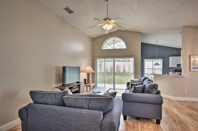 a living room with two couches and a tv at 7 Mi to WDW Indian Ridge Home with Pool Access! in Orlando