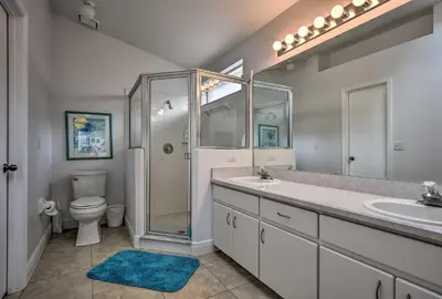 a bathroom with a shower and a sink and a toilet at 7 Mi to WDW Indian Ridge Home with Pool Access! in Orlando
