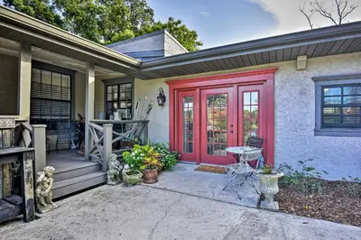 a home with a red door and a porch at Lake Marion Apt with Canoe in Altamonte Springs! in Orlando