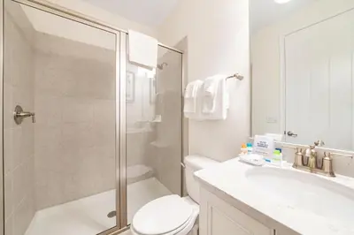 a bathroom with a shower and a toilet and a sink at Sunset Sands Cottage Near Disney With Margaritaville Resort & Island H2O Access - 8065Dr in Orlando