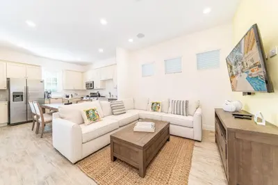 a living room with a couch and a table at Charming Cottage 3 Miles From Disney With Margaritaville Resort & Island H2O Access - 8083Kd in Orlando