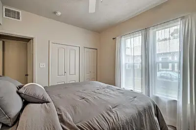 a bedroom with a bed and a large window at Walk to Dtwn Winter Garden Home with Patio in Orlando