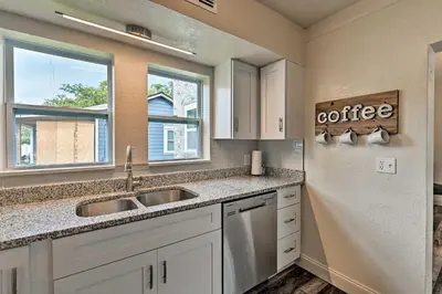 a kitchen with a sink and two windows at Walk to Dtwn Winter Garden Home with Patio in Orlando