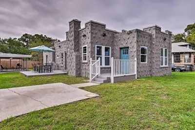 a stone house with a table and a patio at Walk to Dtwn Winter Garden Home with Patio in Orlando
