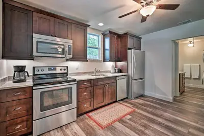 a kitchen with stainless steel appliances and wooden cabinets at Walkable Winter Garden Bungalow 3 Blocks to Dtwn in Orlando