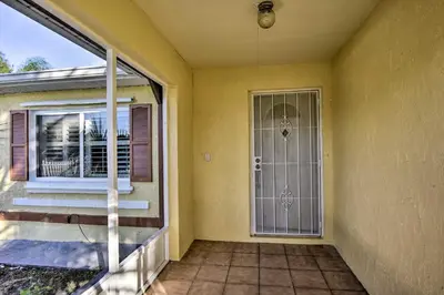 a front door of a house with a porch at Kissimmee Home 5 Mi to Gatorland and 15 Mi to Disney in Kissimmee