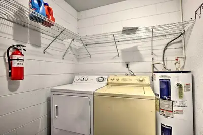 a laundry room with a stove and a refrigerator at Kissimmee Home 5 Mi to Gatorland and 15 Mi to Disney in Kissimmee