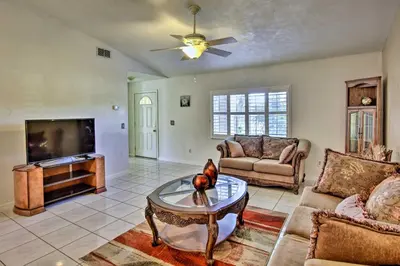 a living room with a couch and a tv at Kissimmee Home 5 Mi to Gatorland and 15 Mi to Disney in Kissimmee