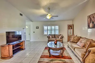 a living room with a couch and a tv at Kissimmee Home 5 Mi to Gatorland and 15 Mi to Disney in Kissimmee
