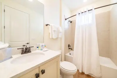 a bathroom with a sink and a toilet and a shower at Darling Five Bedroom Cottage Near Disney With Margaritaville Resort & Island H20 Waterpark Access - 2974La in Orlando