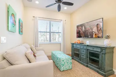 a living room with a couch and a tv at Darling Five Bedroom Cottage Near Disney With Margaritaville Resort & Island H20 Waterpark Access - 2974La in Orlando