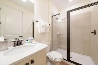a bathroom with a sink and a toilet and a shower at Darling Five Bedroom Cottage Near Disney With Margaritaville Resort & Island H20 Waterpark Access - 2974La in Orlando