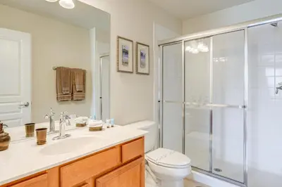 a bathroom with a shower and a toilet and a sink at 3 Mi to WDW Windsor Hills Home with Game Room! in Orlando