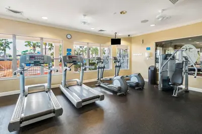 a gym with treadmills and elliptical machines at 3 Mi to WDW Windsor Hills Home with Game Room! in Orlando