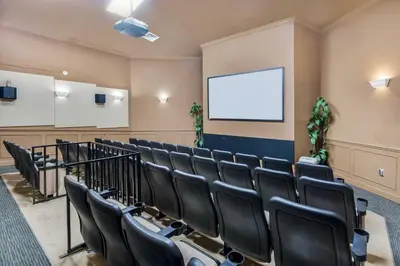 a lecture room with black chairs and a screen at 3 Mi to WDW Windsor Hills Home with Game Room! in Orlando