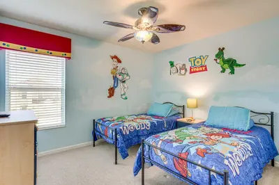 a bedroom with two beds and a ceiling fan at 3 Mi to WDW Windsor Hills Home with Game Room! in Orlando
