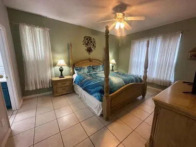 a bedroom with a bed and a ceiling fan at 7 Bedroom, 6 bath and pool near Disney in Emerald Island 4 King Master Suites in Kissimmee
