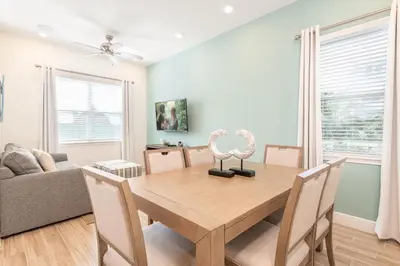 a dining room with a wooden table and chairs at Blue Cascade Cottage Near Disney With Margaritaville Resort & Island H2O Access - 8064Ls in Orlando