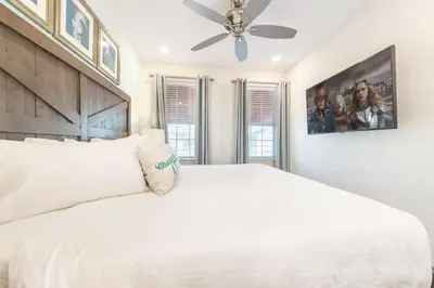 a bedroom with a white bed with a ceiling fan at Blue Cascade Cottage Near Disney With Margaritaville Resort & Island H2O Access - 8064Ls in Orlando