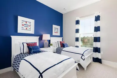 a blue bedroom with two beds and a window at 5min Disney Wonderful Villa, BBQ, SMV102 in Orlando