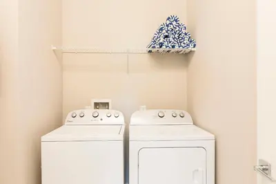 two washing machines in a laundry room with a shelf at 5min Disney Wonderful Villa, BBQ, SMV102 in Orlando