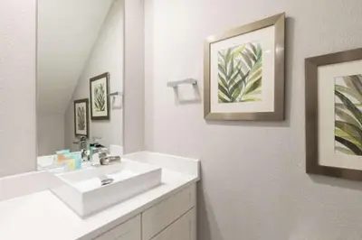 a white bathroom with a sink and a mirror at Cozy Villa 5 Min to Disney w BBQ, SMV104 in Orlando