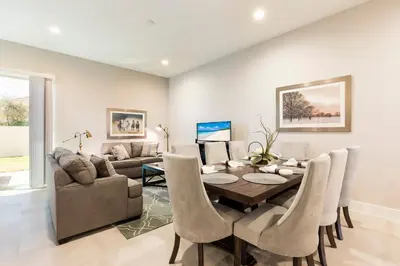 a dining room with a table and chairs and a couch at Cozy Villa 5 Min to Disney w BBQ, SMV104 in Orlando