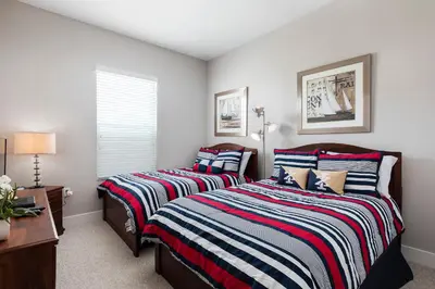 a bedroom with two beds and a desk and a window at Cozy Villa 5 Min to Disney w BBQ, SMV104 in Orlando