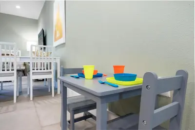a table with plates and bowls on top of it at 5min Disney Cozy Villa, BBQ Grill, SMV108 in Orlando