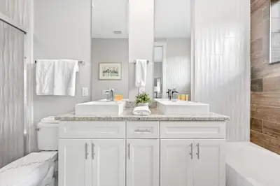 a white bathroom with two sinks and a tub at 5min Disney Cozy Villa, BBQ Grill, SMV108 in Orlando
