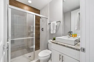a white bathroom with a toilet and a sink at 5min Disney Cozy Villa, BBQ Grill, SMV108 in Orlando