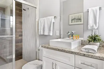 a white bathroom with a sink and a shower at 5min Disney Cozy Villa, BBQ Grill, SMV108 in Orlando