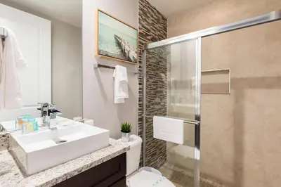 a bathroom with a sink and a shower at 4 BR 4 BA Deluxe Villa 5 min to Disney Family getaway in Orlando