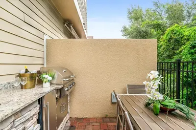 a patio with a bench next to a wall at 4 BR 4 BA Deluxe Villa 5 min to Disney Family getaway in Orlando