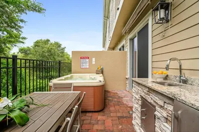 a hot tub sitting on a patio next to a table at 4 BR 4 BA Deluxe Villa 5 min to Disney Family getaway in Orlando