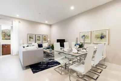 a dining room with a glass table and white chairs at 5min Disney Fantastic Townhome, BBQ 116 in Orlando