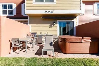 a patio with a table and chairs and a grill at 5min Disney Fantastic Townhome, BBQ 116 in Orlando