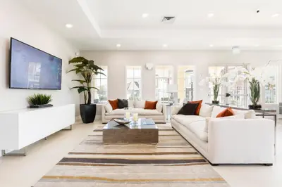 a living room with white furniture and a flat screen tv at 5min Disney Fantastic Townhome, BBQ 116 in Orlando