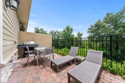 a patio with two chairs and a grill at Ultra convenient stay, 5 min to Disney SMV118 in Orlando