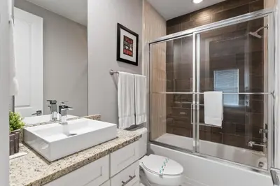 a bathroom with a sink and a toilet and a shower at Ultra convenient stay, 5 min to Disney SMV118 in Orlando