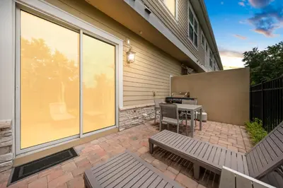 a patio with a bench and a table with a grill at Ultra convenient stay, 5 min to Disney SMV118 in Orlando