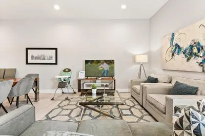 a living room with a couch and a table at Ultra convenient stay, 5 min to Disney SMV118 in Orlando