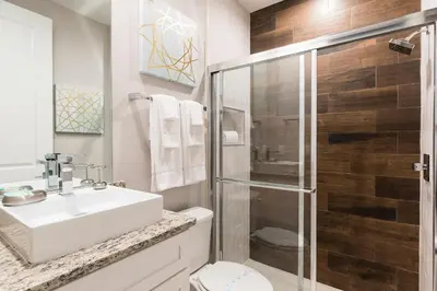 a bathroom with a toilet and a sink and a shower at Amazing Family Villa 5min Disney w BBQ 128 in Orlando